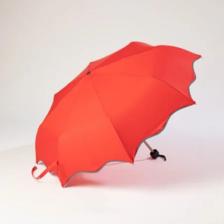 Mini red umbrella opened on the side