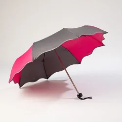 Mini grey and pink umbrella with wave pattern, open from the front