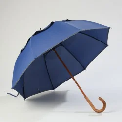 Windproof umbrella in french blue with black polka dot trim, front opening