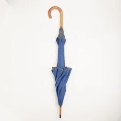 Windproof umbrella in french blue with black polka dot trim, closed