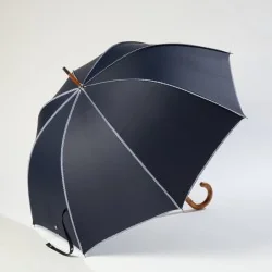 Navy blue walking umbrella with sailor-style trim, opens from the side