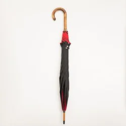 Black walking umbrella with red trim, closed