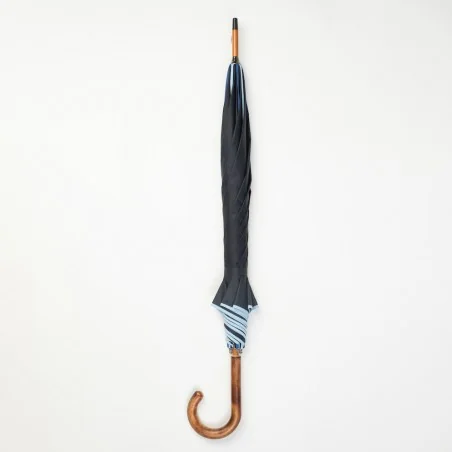 Navy blue walking umbrella trimmed with shades of blue, closed